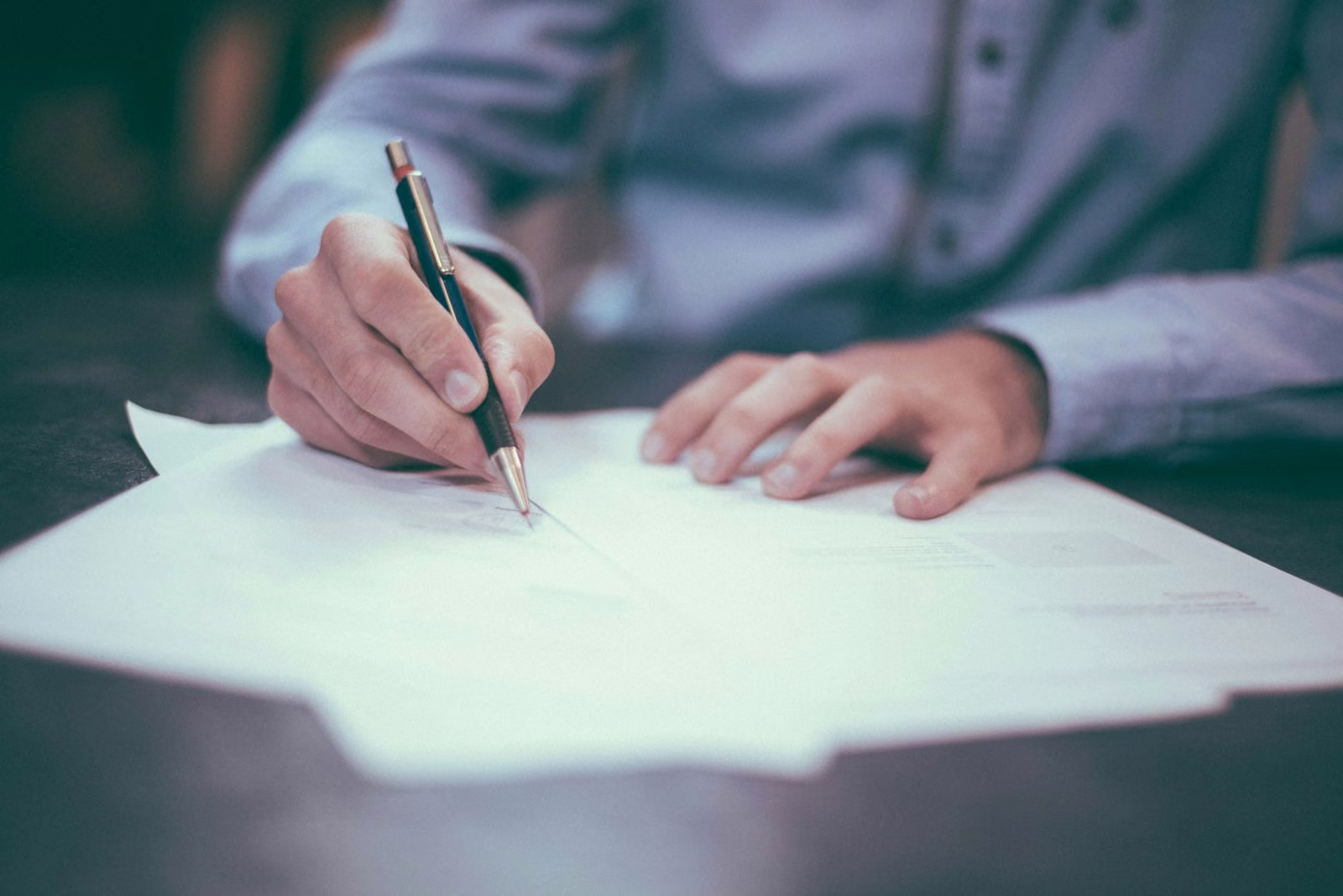 An attorney reviewing and signing documents.